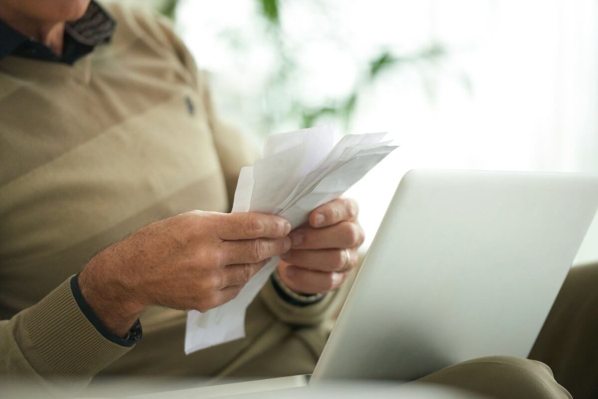 Bills and receipts in hands of senior man